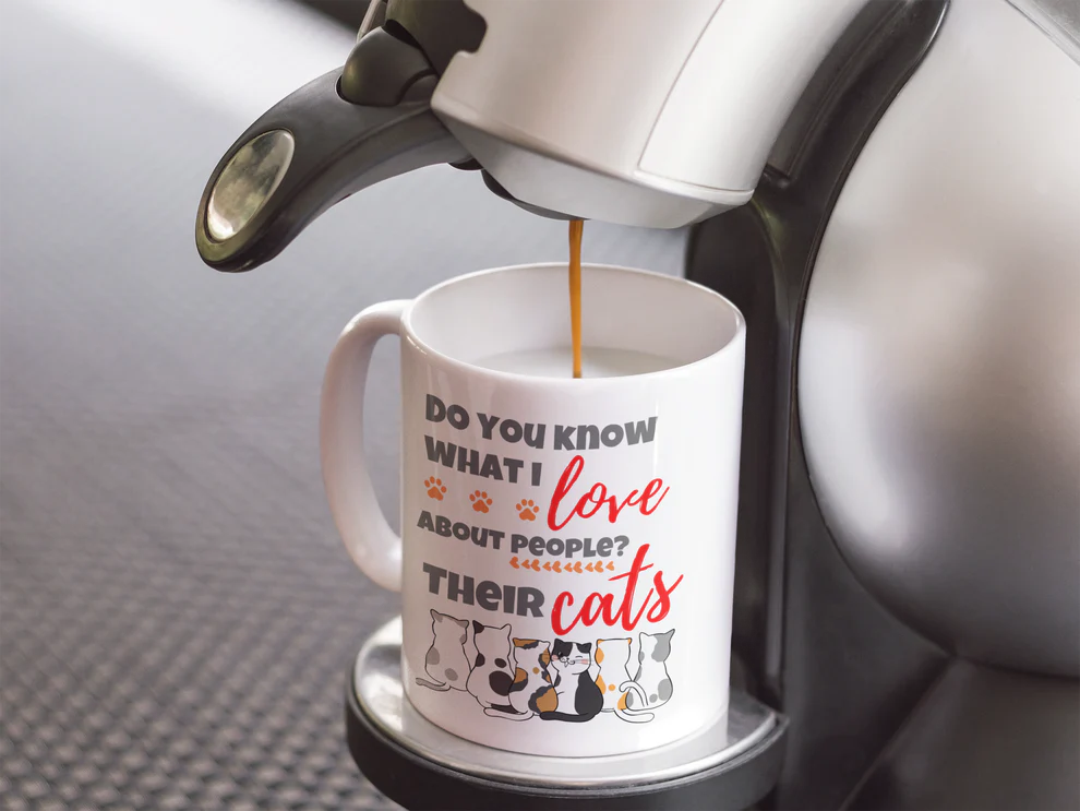 Coffee being poured into a mug with a humorous cat-themed message.