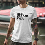man with arm tattoos and a chunky watch wearing a white unisex t-shirt that says "best cat dad ever"